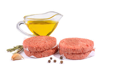 Raw beef patties for making a burger.Isolated on a white background.Fast food.Selective focus.の写真素材