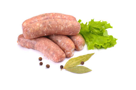 Raw pork sausages. Grilled sausages, spices close-up, isolated on a white background. Selective focus.Horizontal view.の写真素材