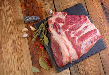 Raw pork ribs. Top the meat ingredient on a slate serving board. top view, close-up. Selective Focusの写真素材