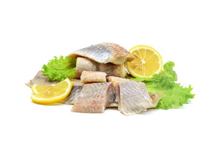 Atlantic salted herring fillet with onion ring, lemon, and pepper, isolated on a white background, horizontal viewの写真素材