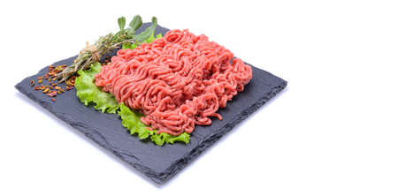 Fresh minced pork and beef and spices on a slate stone.Isolated on a white background, selective focus. horizontal viewの写真素材