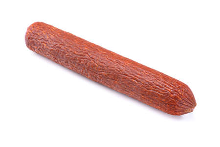 Stick of raw smoked sausage close-up. Isolated on a white backgroundの写真素材