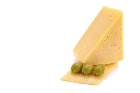 A piece of hard yellow cheese with olives, close-up, isolated on a white background.selective focus.の写真素材