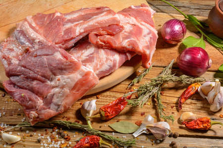 Raw pork ribs. Top the meat ingredient on a slate serving board. top view, close-up. Selective Focusの写真素材