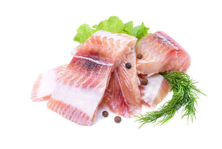 Pangasius fish fillet, pieces on a green lettuce leaf. Isolated on a white background. Fresh Fish Fillet. The view from the topの写真素材