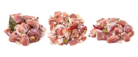 Raw pieces of pork shish kebab in marinade with pepper, onion, bay leaf, ready to cook, barbecue meat, isolated on a white background. Top view. Selective Focus.の写真素材