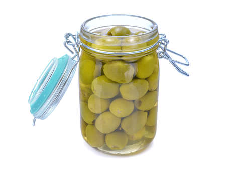 green pickled olives in a glass jar, isolated on a white backgroundの写真素材