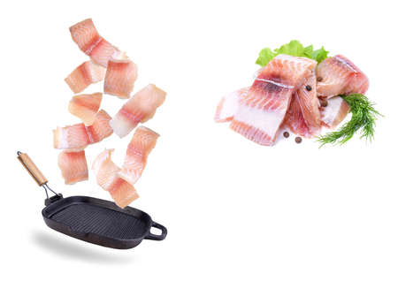 A steak of flying fish falls into the pan. The effect of flying motion in the cooking process.Isolated objects on a white background. Flying food.の写真素材
