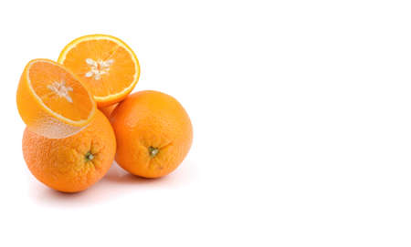 juicy orange fruits are whole and cut in half, isolated on a white background.の写真素材