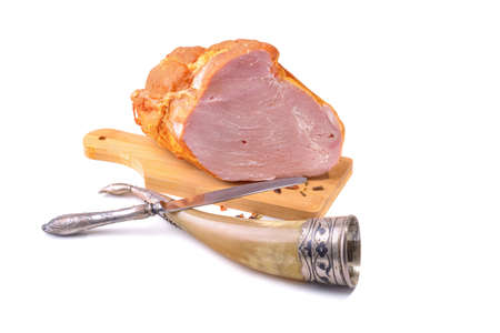 Smoked meat or ham large cut piece on a wooden board, isolated on a white background horizontal viewの写真素材