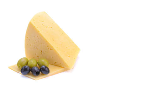 A piece of hard yellow gouda cheese with olives close-up, isolated on a white background.selective focus.の写真素材