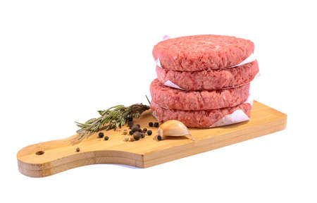 Raw beef patties for making a burger.Isolated on a white background.Fast food.Selective focus.の写真素材