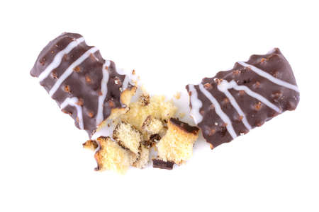 Broken chocolate chip cookies. Pieces and crumbs of a chocolate stick or bar are isolated on a white background. Top Viewの写真素材