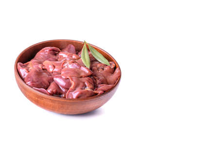 raw chicken or goose liver with bay leaf in a clay bowl close-up, isolated on a white background.の写真素材