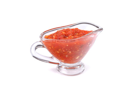 Tomato sauce, adjika in a glass cup isolated on a white backgroundの写真素材