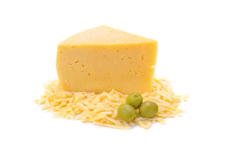 Hard yellow gouda cheese and grated cheese with green olives close-up, isolated on a white background.selective focus.の写真素材
