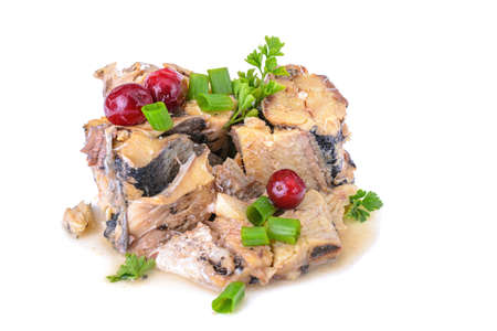 canned fish with cranberries and parsley is isolated on a white background.の写真素材