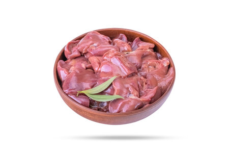 raw chicken or goose liver with bay leaf in a clay bowl close-up, isolated on a white backgroundの写真素材