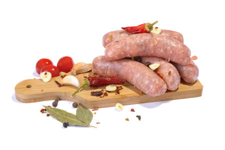 Raw pork sausages.Grilled sausages in close-up, isolated on a white background.Selective focus.の写真素材