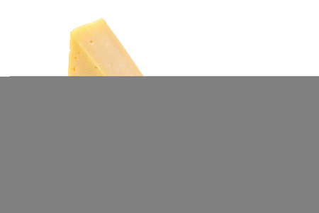 A piece of hard yellow cheese with olives in close-up, isolated on a white backgroundの写真素材