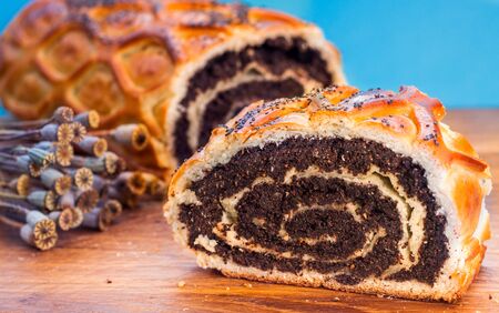 Poppy seed Roll on a wooden desk, closeupの写真素材