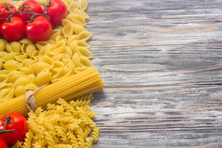 Set various raw ingredients for cooking Italian pasta on gray table, top viewの写真素材