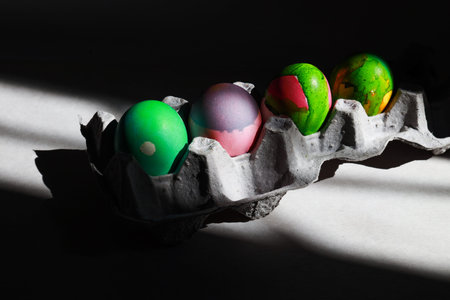 easter eggs with abstract vibrant homemade design in a cart, shooted in hard light