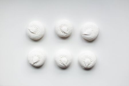 White sweet dessert zephyr marshmallows on white background. Confectionery. Even, organized, simple.の写真素材