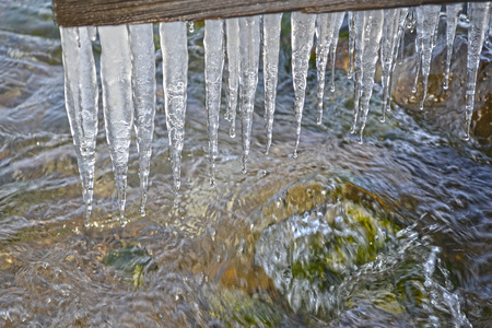 Icicles of baikal water ice shore stoneの写真素材