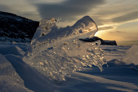 Siberia winter. Piece fo ice in rays of sunsetの写真素材