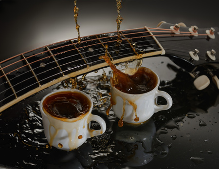 Concept acoustic guitar and two cups of coffee.の写真素材