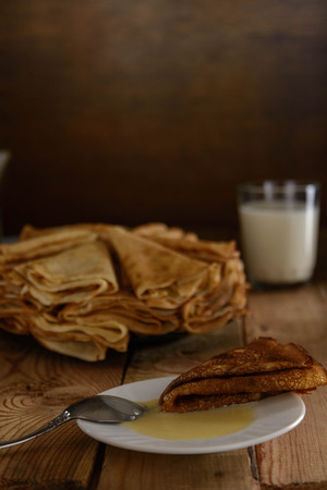 Pancakes with sweet condensed milk on the table.の写真素材