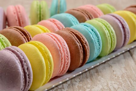 French colorful macarons on the wooden table.の写真素材