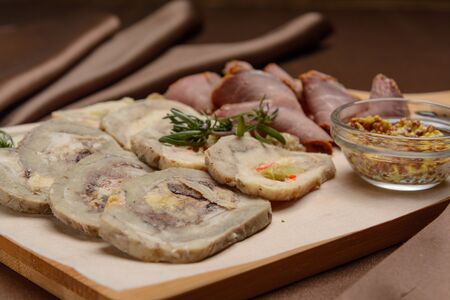 Sliced meat on a board with greens. For the menuの写真素材
