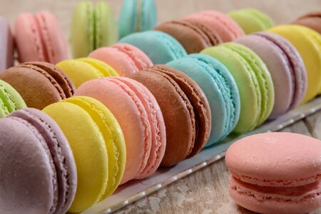 French colorful macarons on the wooden table.の写真素材