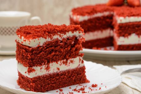 Cake red velvet. Cut piece on a plate. Wood backgroundの写真素材