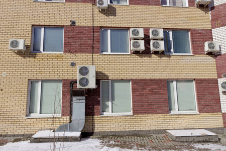 A fragment of a multi-storey brick residential building with installed air conditioning. Nizhny Novgorod. Russiaの写真素材
