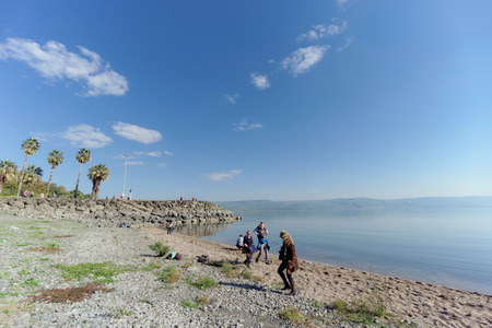 Israel. - February 17.2017. Tourists are walking on the shore on the stone embankment of the Sea of Galilee in Israel.のeditorial素材