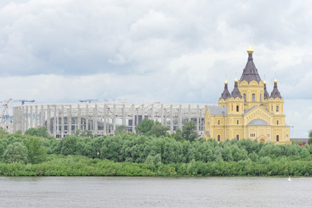 Nizhny Novgorod, Russia. - June 27.2017. Construction of the stadium in Nizhny Novgorod to the FIFA World Cup 2018 and the Cathedral of Alexander Nevskyのeditorial素材