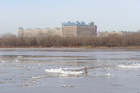 Nizhny Novgorod, Russia. - March 24.2017.View of Marins Park Hotel from the other side of the Oka. The remains of ice floes are floating on the dark waterのeditorial素材