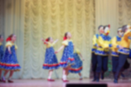 Folk dances of children and teens theme abstract blur background with bokeh effect.の写真素材