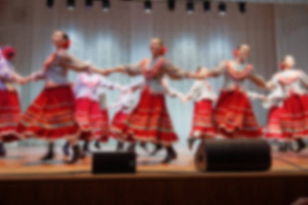 Folk dances of children and teens theme abstract blur background with bokeh effect.の写真素材