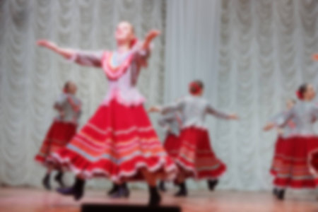 Folk dances of children and teens theme abstract blur background with bokeh effect.の写真素材