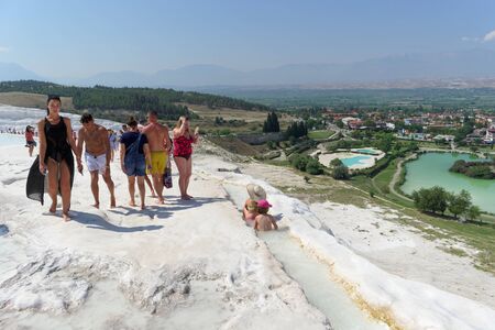 Denizli, Turkey. - July 20.2019. Tourists walk on a snow-white terraces at Pamukkale in Turkey.のeditorial素材