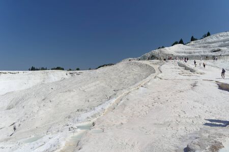 Denizli, Turkey. - July 20.2019. Tourists walk on a snow-white terraces at Pamukkale in Turkey.のeditorial素材