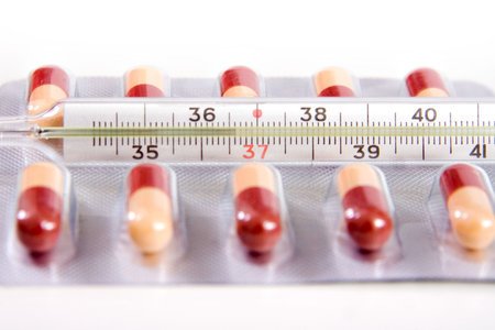 pills and thermometer 36,6