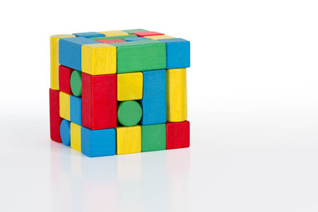 jigsaw puzzle cube toy, multicolored wooden pieces, colorful game bricks isolated on white 