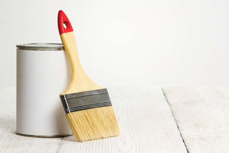 Paintbrush and can, paint brush and white color container on wooden floor background
の写真素材