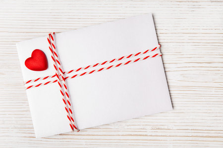 Envelope Mail with Red Heart and Ribbon over White Wooden Background. Valentine Day Card, Love or...