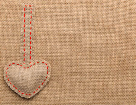 Heart Shape Sackcloth Sewing Object. Mended Burlap Background. Valentine Day Burlap or Wedding Love concept.の写真素材